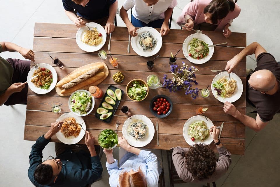 Colleagues sharing lunch together in an office cafeteria