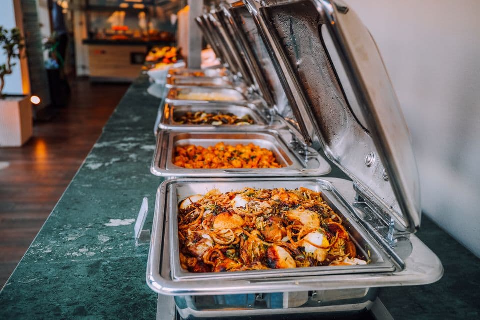 Hotel buffet with dishes in stainless steel chafing dishes